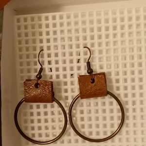 Leather and circle ring earrings.